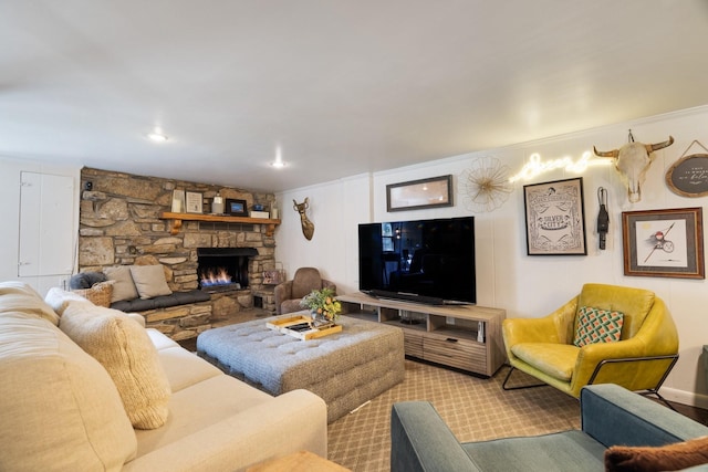 living room featuring a stone fireplace and ornamental molding