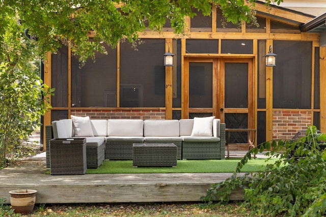 deck with outdoor lounge area and a sunroom