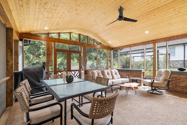 sunroom / solarium with vaulted ceiling, ceiling fan, and wood ceiling