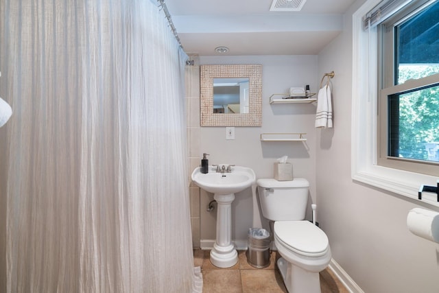 bathroom featuring tile patterned floors and toilet