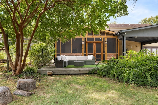 view of yard featuring outdoor lounge area, a sunroom, and a wooden deck