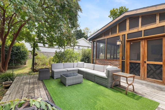 wooden deck with a sunroom and an outdoor living space