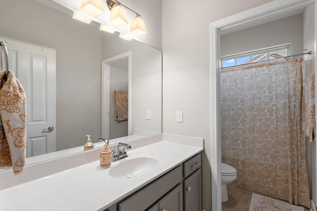 bathroom with tile patterned floors, vanity, and toilet