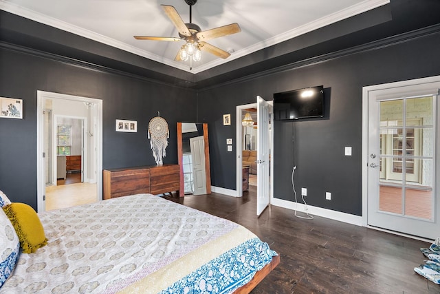 bedroom featuring dark hardwood / wood-style flooring, a raised ceiling, ceiling fan, and ornamental molding