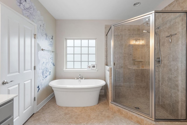 bathroom featuring vanity, tile patterned flooring, and plus walk in shower