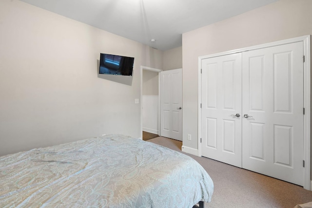 carpeted bedroom with a closet