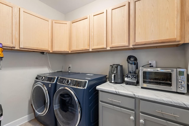 washroom featuring cabinets and independent washer and dryer