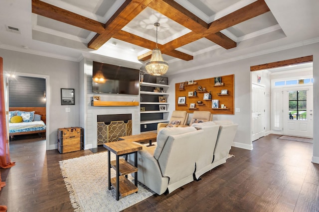 living room featuring a brick fireplace, a chandelier, ornamental molding, and coffered ceiling