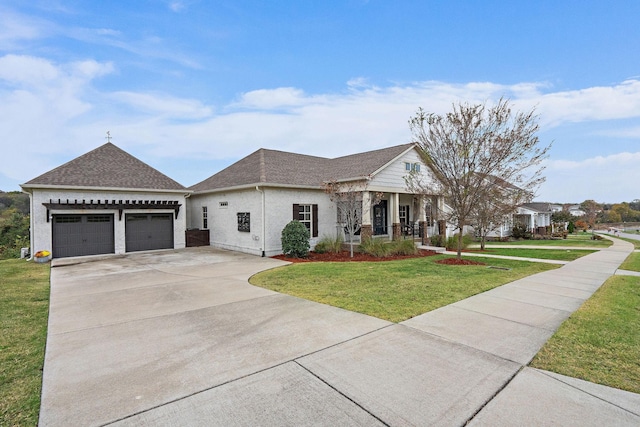 view of front facade with a front lawn, covered porch, and a garage