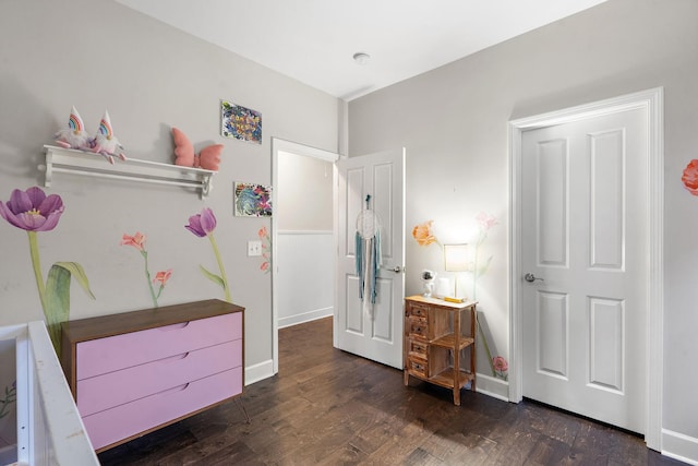 bedroom with dark wood-type flooring