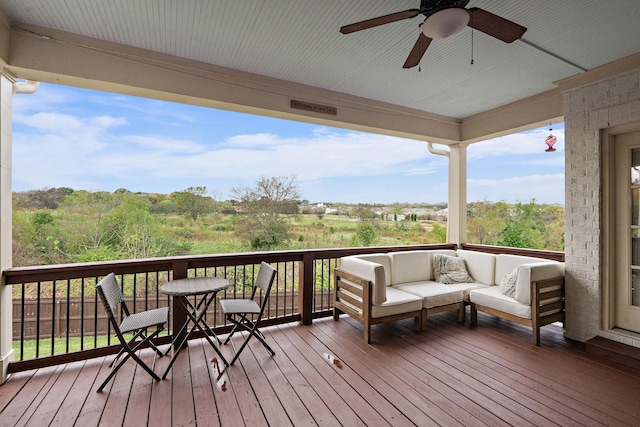 wooden deck featuring an outdoor hangout area and ceiling fan