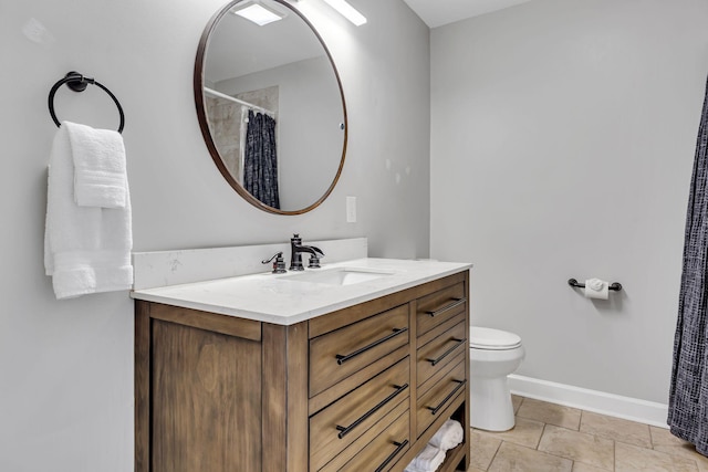 bathroom featuring tile patterned floors, vanity, and toilet