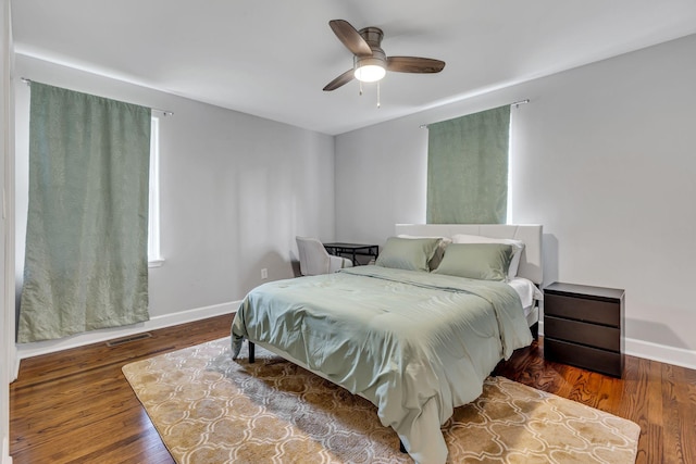 bedroom with ceiling fan and dark wood-type flooring