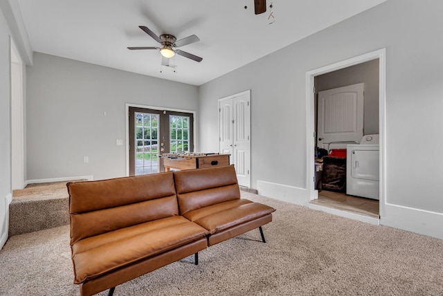 carpeted living room featuring washer / dryer, french doors, and ceiling fan