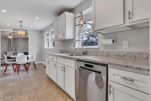 kitchen with dishwasher, white cabinetry, sink, and a wealth of natural light