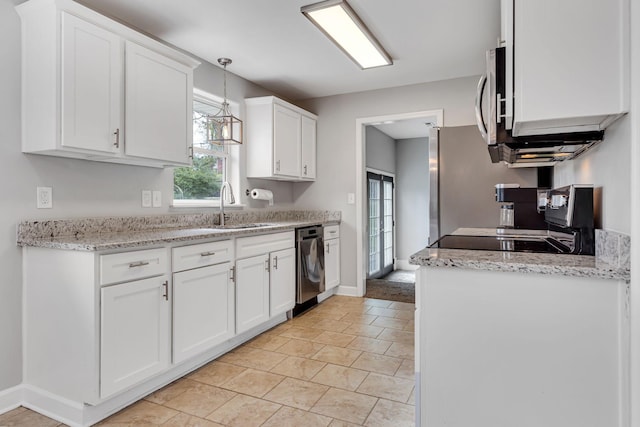 kitchen with white cabinets, pendant lighting, sink, and stainless steel appliances