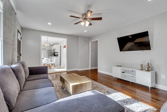 living room featuring ceiling fan and wood-type flooring