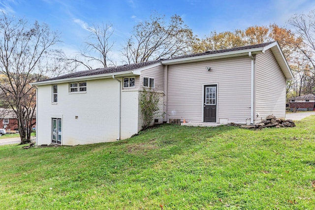 rear view of house with a yard