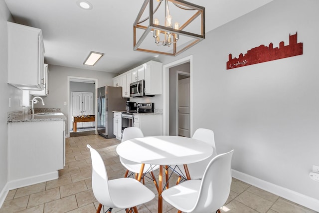 dining area with sink and a notable chandelier