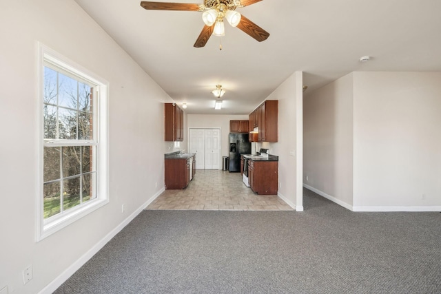 kitchen featuring light carpet, black fridge, a wealth of natural light, and ceiling fan