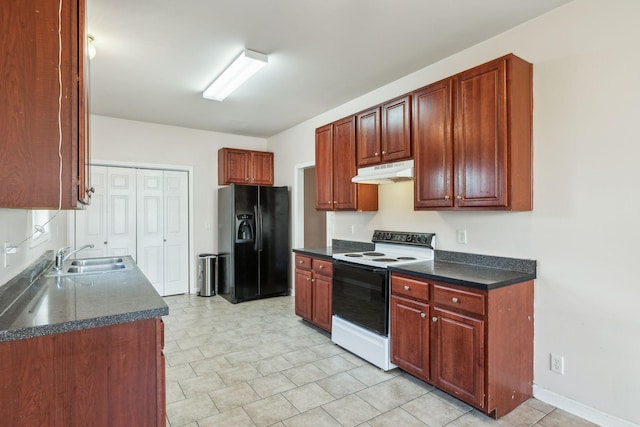 kitchen with black fridge, electric range, and sink