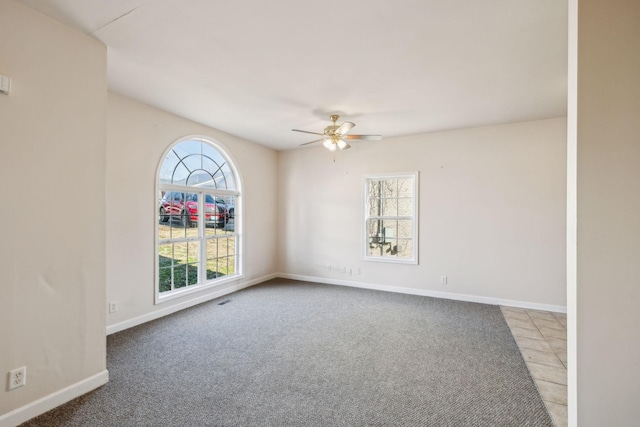 empty room with carpet flooring and ceiling fan