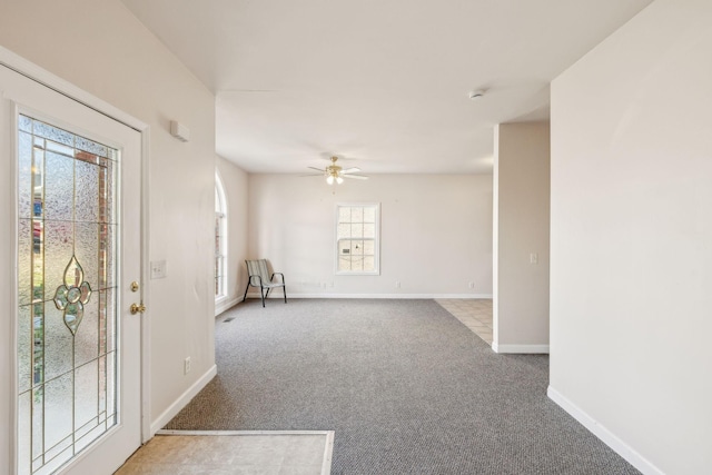 empty room featuring ceiling fan and light colored carpet