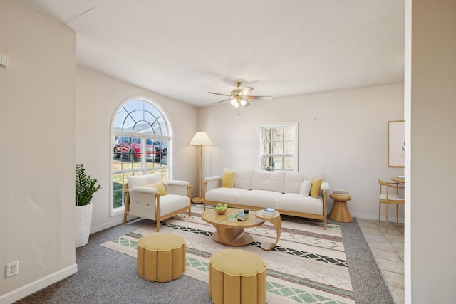 living room with ceiling fan and carpet