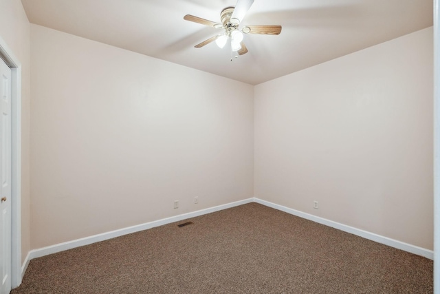 unfurnished room with ceiling fan and carpet