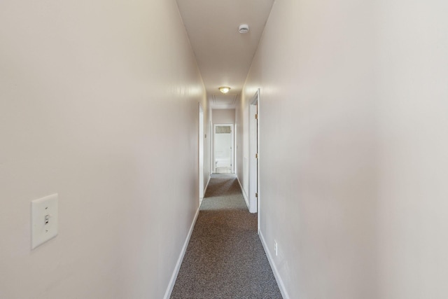 corridor featuring dark colored carpet