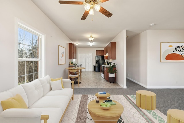 living room featuring light carpet and ceiling fan