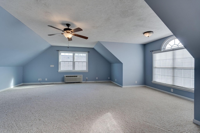 additional living space featuring a textured ceiling, ceiling fan, light carpet, and lofted ceiling