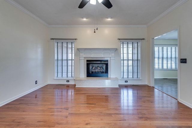 unfurnished living room with ceiling fan, hardwood / wood-style floors, and crown molding