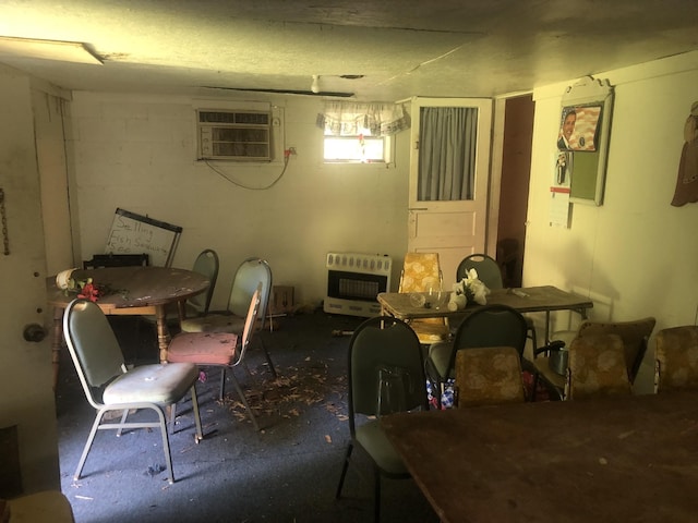 basement with heating unit, a fireplace, and a wall mounted air conditioner