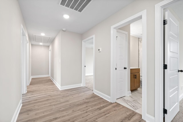 hallway featuring recessed lighting, visible vents, attic access, light wood-style floors, and baseboards