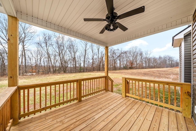 wooden deck featuring ceiling fan and a yard