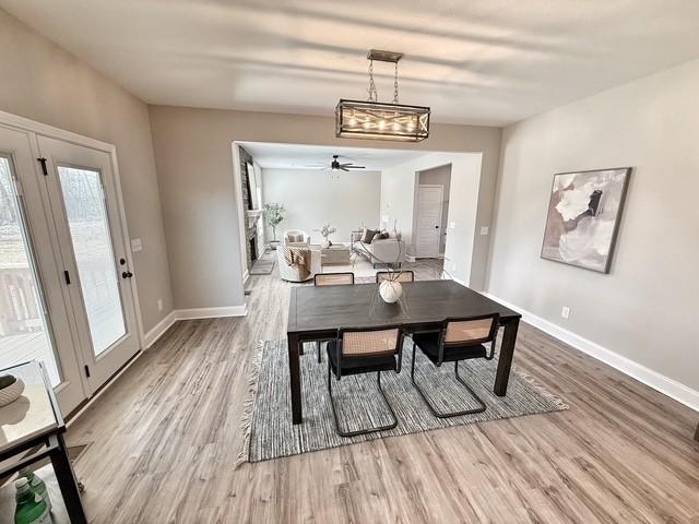 dining space with baseboards and wood finished floors