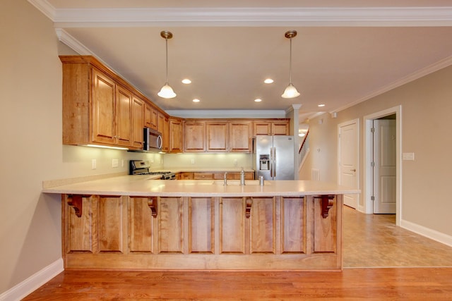 kitchen with sink, hanging light fixtures, stainless steel appliances, kitchen peninsula, and crown molding