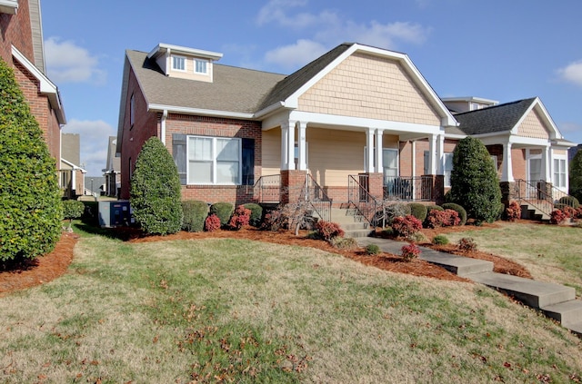 craftsman-style home with a porch and a front lawn