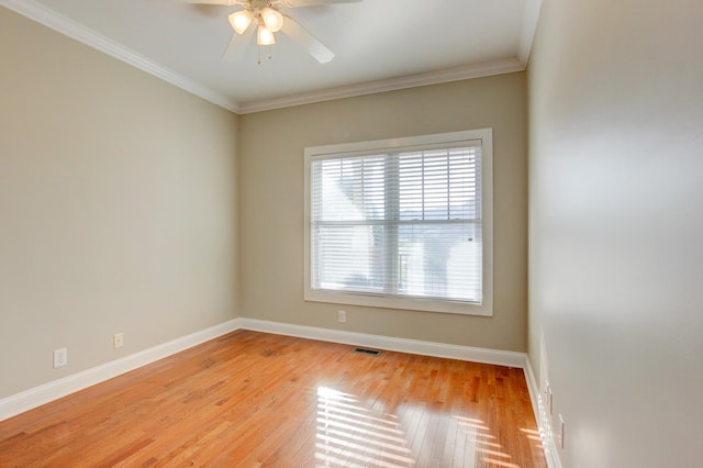 empty room with ceiling fan, light wood-type flooring, and ornamental molding