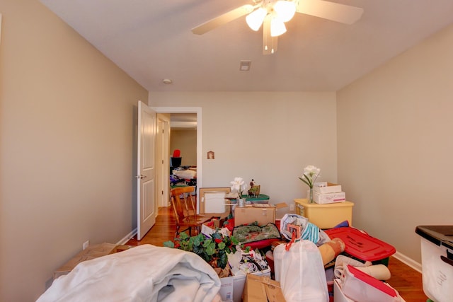 bedroom with ceiling fan and hardwood / wood-style flooring