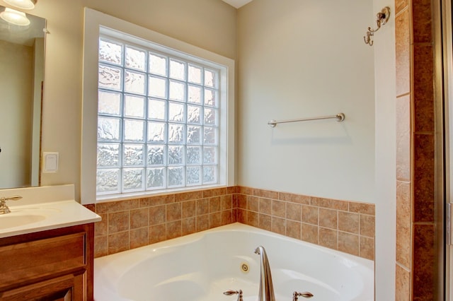 bathroom featuring a washtub, vanity, and plenty of natural light