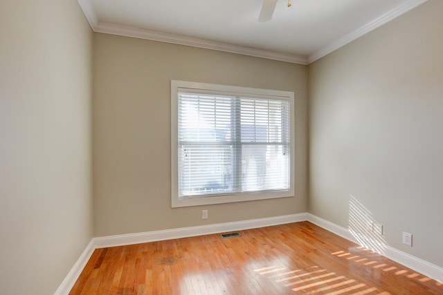 empty room with ceiling fan, light hardwood / wood-style floors, and ornamental molding