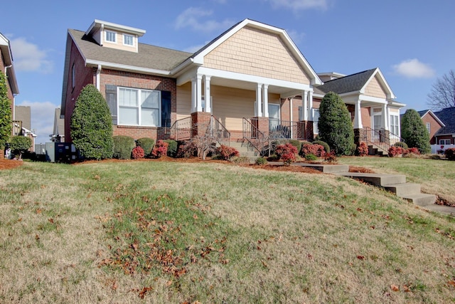 craftsman house featuring a front lawn and a porch