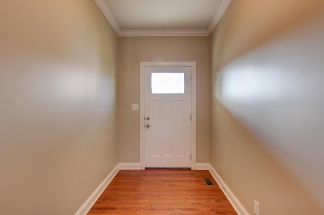 entryway featuring ornamental molding and light wood-type flooring