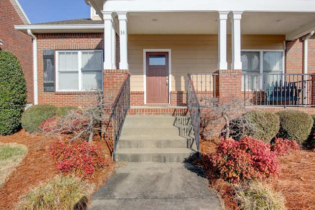 entrance to property featuring covered porch