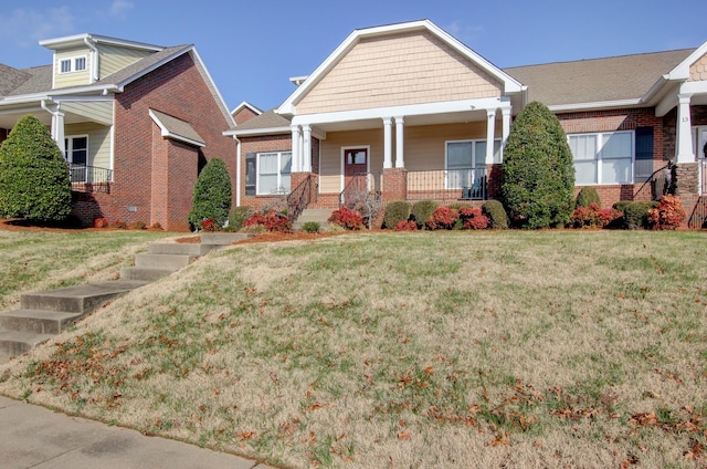 craftsman-style house with a porch and a front lawn