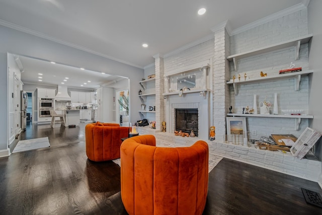 living room with dark hardwood / wood-style flooring, a fireplace, built in features, and ornamental molding