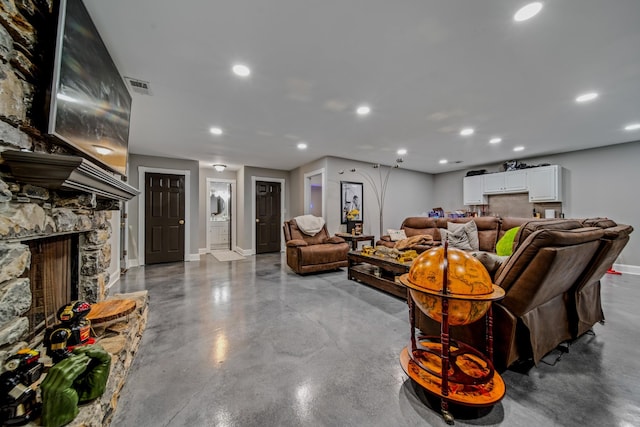 living room featuring a fireplace and concrete floors