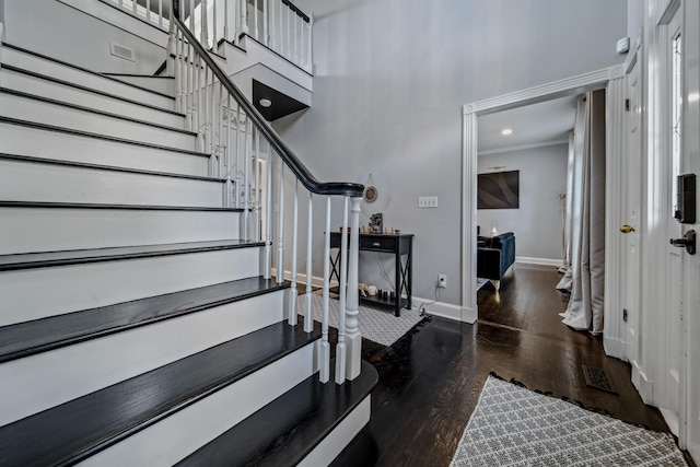 foyer with crown molding and dark hardwood / wood-style floors